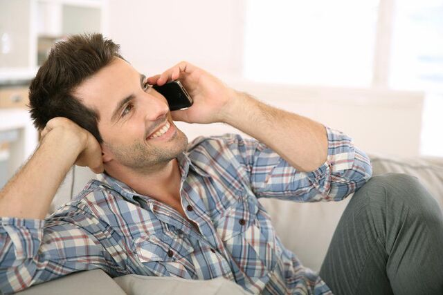 A man, feeling awake, talks to a woman for a long time on the phone. 